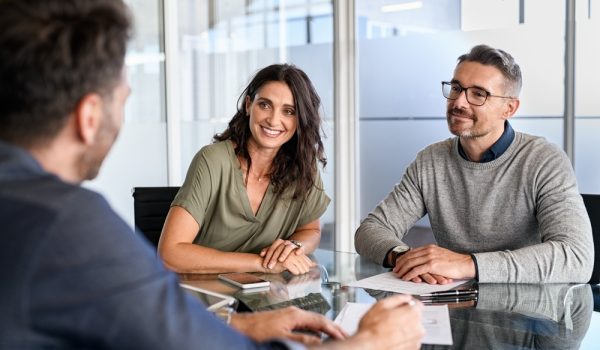 Smiling,Mature,Couple,Meeting,With,Bank,Manager,For,Investment.,Mid